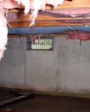 Oregon crawl space with vents, showing mold, rot, and fiberglass insulation dripping off the ceiling.