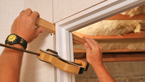 Installing trim and finishing touches to a remodeled basement in Springfield, OR