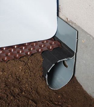 Closeup of a crawl space drainage system installed in Camas