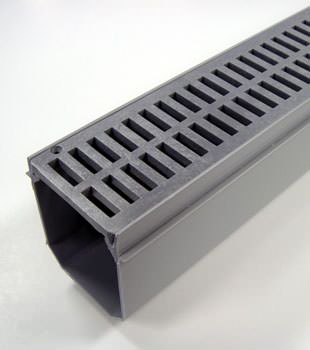 A closeup of our grated basement drainage pipe system, installed in Woodburn