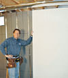 Installing wall panels on top of our basement wall insulation in Hillsboro