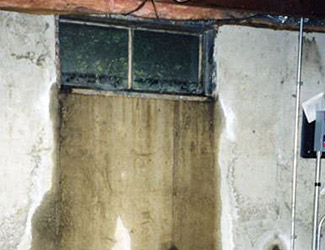 Water pouring out from a basement window in Beaverton